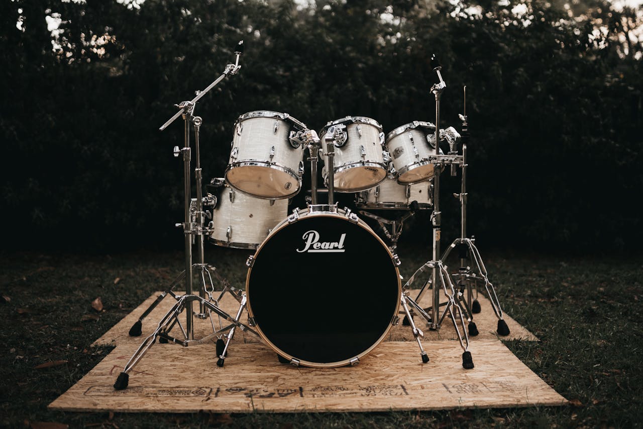 A classic Pearl drum set displayed outdoors, perfect for music enthusiasts.